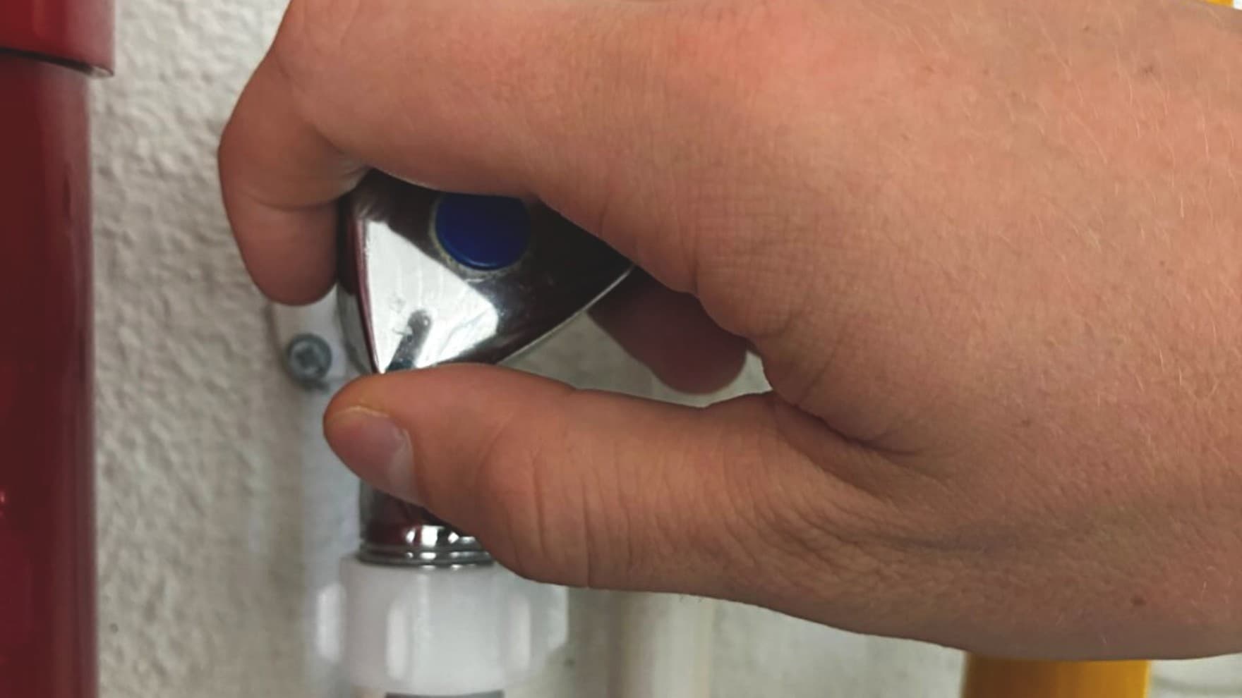 Hand sluit een waterkaan