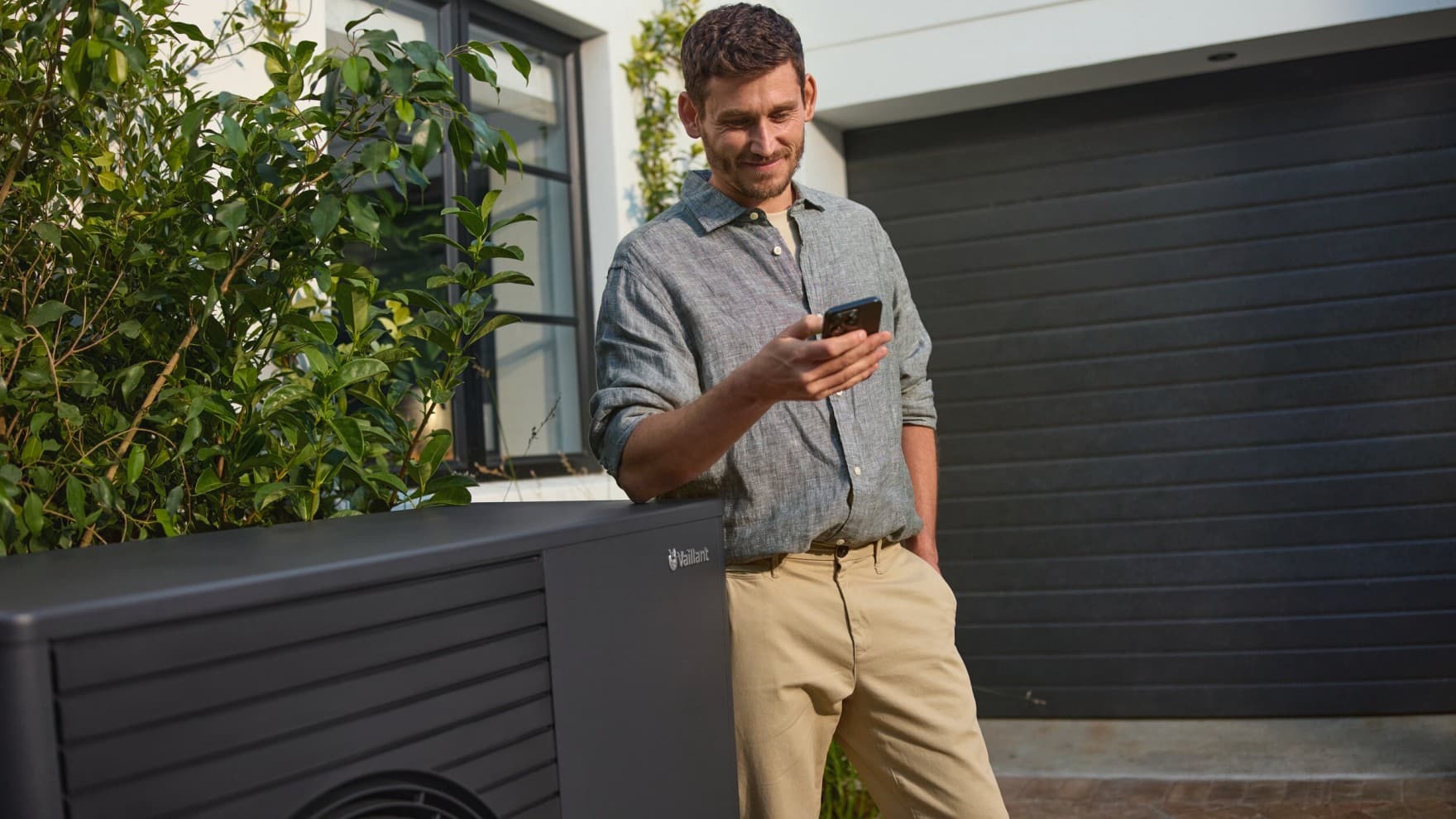 Man bekijkt verbruik van zijn warmtepomp op telefoon